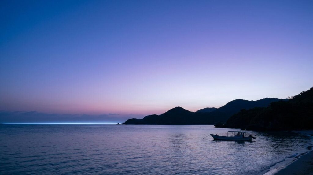 Sunrise beyond the Okinawan sea colouring the eastern sky with vivid light